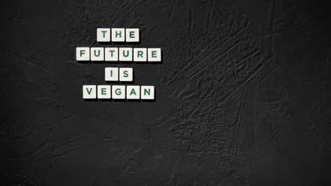 Stop motion sign the future is Vegan with rough black backdrop and copy space Stock Footage 218031776