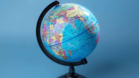 Stop motion of spinning globe isolated on blue background. Stock Footage 251410761