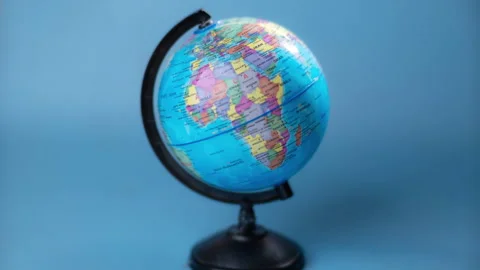 Stop motion of spinning globe isolated on blue background. Stock Footage 251410798