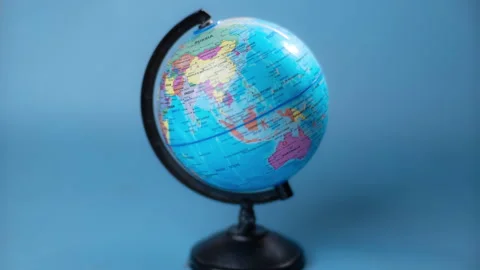 Stop motion of spinning globe isolated on blue background. Stock Footage 251410927