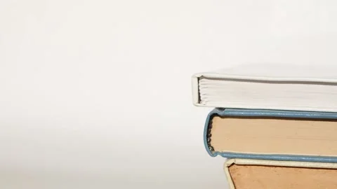 Stop motion stack of books appears. Looped 4k video. Video stock 157432077