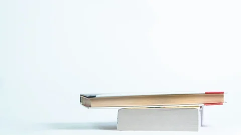 Stop motion of a stack of old books on a white background Stock Footage 129569683