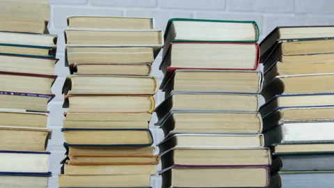 Stop motion stacking old books on a black background. Timelapse Video stock 123540320