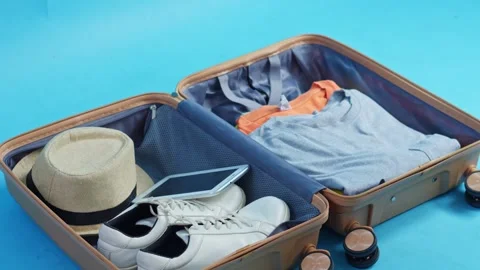 Stop-motion of suitcase being packed with travel essentials like clothes Vídeos de archivo 331161125
