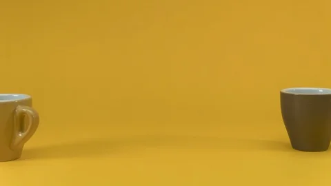 Stop motion of three coffee cups dancing on a yellow background, 4k loop Stock-Footage 128561463