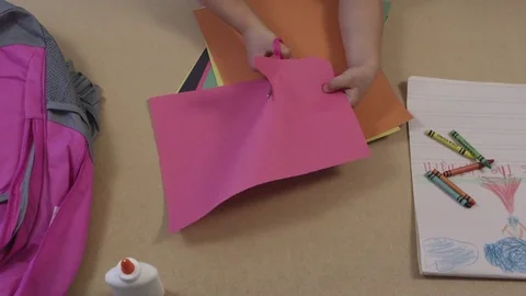 Stop motion top view of young child cutting construction paper Stock-Footage 80132123