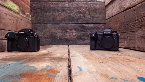Stop Motion Of Two Panasonic S1H  DSLR Cameras Spinning Background Stock Footage 131000612