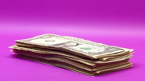 Stop motion US dollar banknotes stack growing layer by layer on pink background Stock Footage 343413397