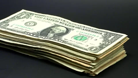 Stop motion US dollar banknotes stack growing layer by layer on black background Stock Footage 343413419