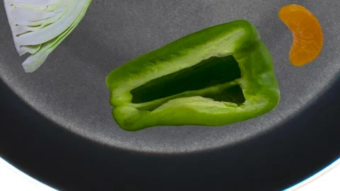 Stop motion of the vegetables in a black skillet. Healthy nutrition concept. Stock Footage 167403106