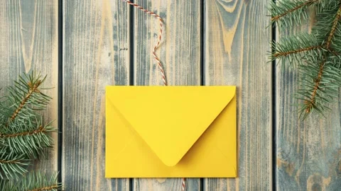 Stop motion video of bright yellow opening envelope on gray wooden background Stock Footage 221622816