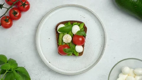 Stop motion video of cooking and eating vegetarian open sandwich. Stock Footage 163725567
