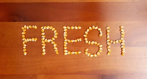 Stop motion video of corn kernel forming the word "fresh". Video stock 160432642