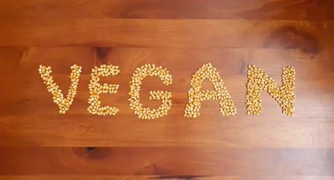Stop motion video of corn kernel forming the word "vegan". Stock Footage 160432649