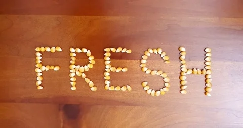 Stop motion video of corn kernel forming the word "corn". Video stock 160498188