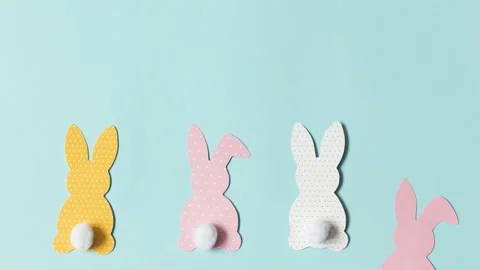 Stop motion video, easter paper colorful bunnies on blue background Stock Footage 150360812