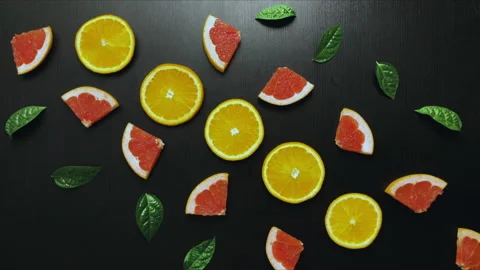 Stop motion video fruit. Slices of grapefruit and orange move Stock Footage 161178201