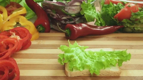 Stop motion video of making sandwich with ham, cheese and salad. Glass of beer Stock Footage 87787937