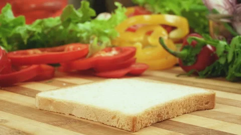 Stop motion video of making sandwich with tomato, ham, bow, cheese and salad Stock Footage 87802730