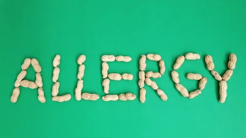 Stop motion video of peanuts forming the word "Allergy". Stock Footage 161262182