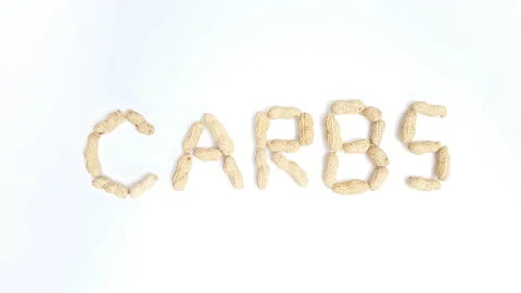 Stop motion video of peanuts forming the word "Carbs". Stock Footage 161349794