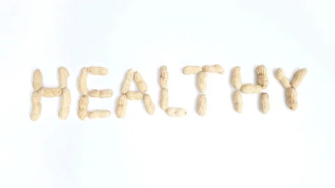 Stop motion video of peanuts forming the word "Healthy". Stock Footage 161349889