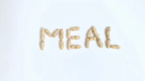 Stop motion video of peanuts forming the word "Meal". Stock Footage 161350750
