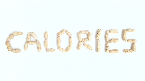 Stop motion video of peanuts forming the word "Calories". Stock Footage 161350808