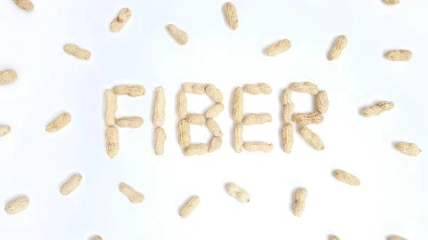 Stop motion video of peanuts forming the word "Fiber". Stock Footage 161351078