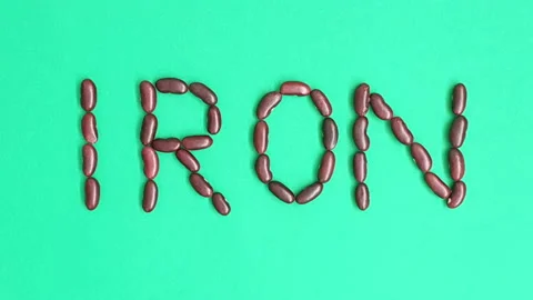 Stop motion video of red kidney bean forming the word "Iron". Stock Footage 161911768