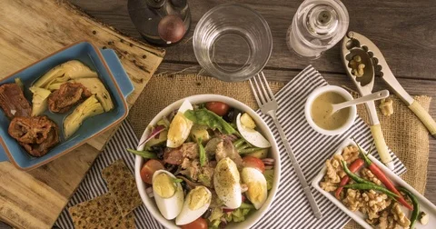 Stop motion view of the preparation of a fresh, healthy, organic nicoise salad Stock Footage 71588938
