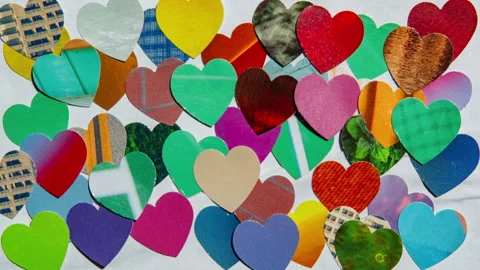 Stop motion of white paper was covered by colorful heart-shaped magazine papers Stock Footage 326885040