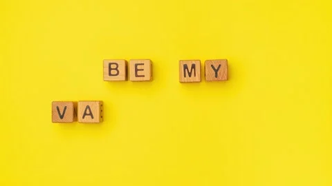 Stop-motion wooden cubes with the phrase Be My Valentine on an empty colorful Stock Footage 232136186
