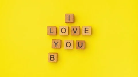 Stop-motion wooden cubes with the phrase I Love You Baby on an empty colorful Stock Footage 235457172