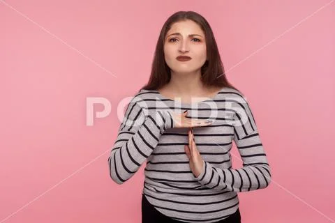 Stop, need break! Portrait of tired unhappy woman in striped sweatshirt showi Stock Photos
