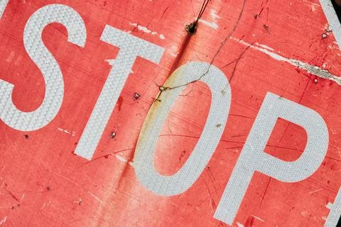 STOP, old, faded stop sign, chipped, fading red paint, metallic texture Stock Photos