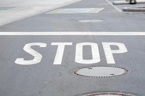 STOP painted on asphalt Stock Photos