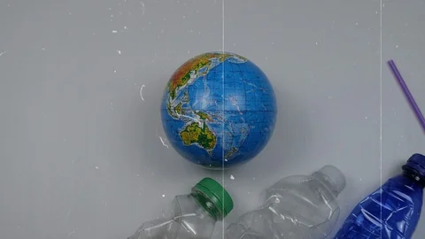 Stop plastic pollution. Earth surrounded by plastic waste. Plastic bottles, c Stock Footage 121584770