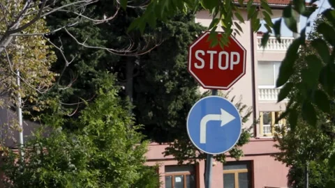 STOP road sign. Close-up of Stop and right turn road signs on a residential Stock Footage 315177950
