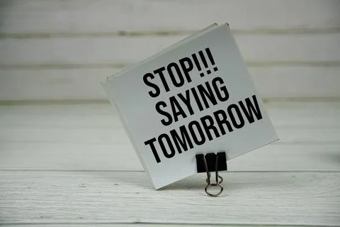 Stop Saying Tomorrow text message write on sticky note on wooden background Stock Photos