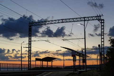 Stop of a shuttle train without people on the background of orange sunset Stock Photos