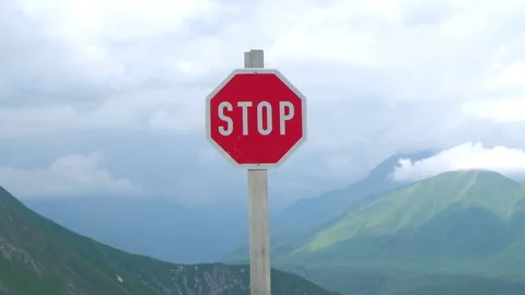 Stop Sign Against Mountain Range and Low Clouds 스톡 동영상 255124570