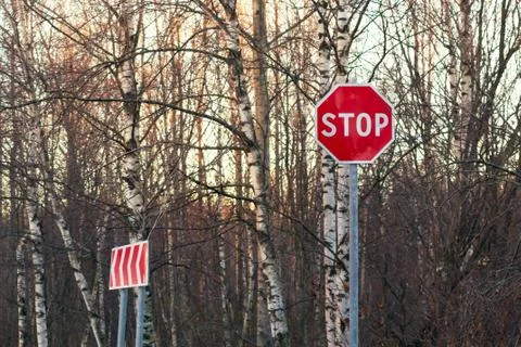 Stop sign and detour on the side of an asphalt road Stock Photos