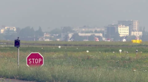 Stop sign and a flashing light at the airport tarmac Video stock 63750652
