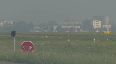 Stop sign and a flashing light at the airport tarmac Video stock 63755548