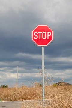Stop sign, cloudy sky Stock Photos