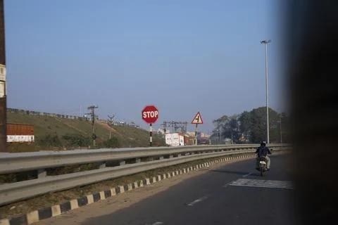 A stop sign display on the side of highway Stock Photos