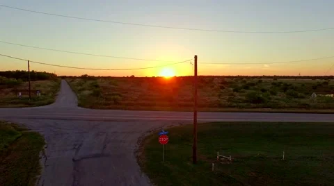Stop sign at an intersection at sunset Stock Footage 53095566