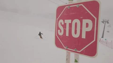 Stop sign on top of mountain at winter snowy ski resort Stock Footage 103853341