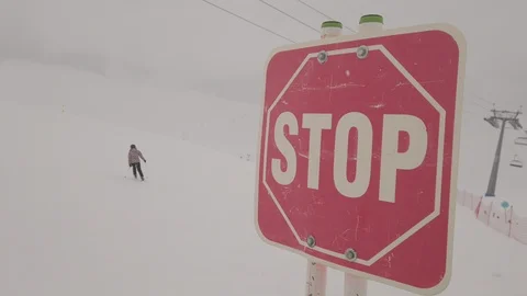Stop sign on top of mountain at winter snowy ski resort Stock Footage 103853484